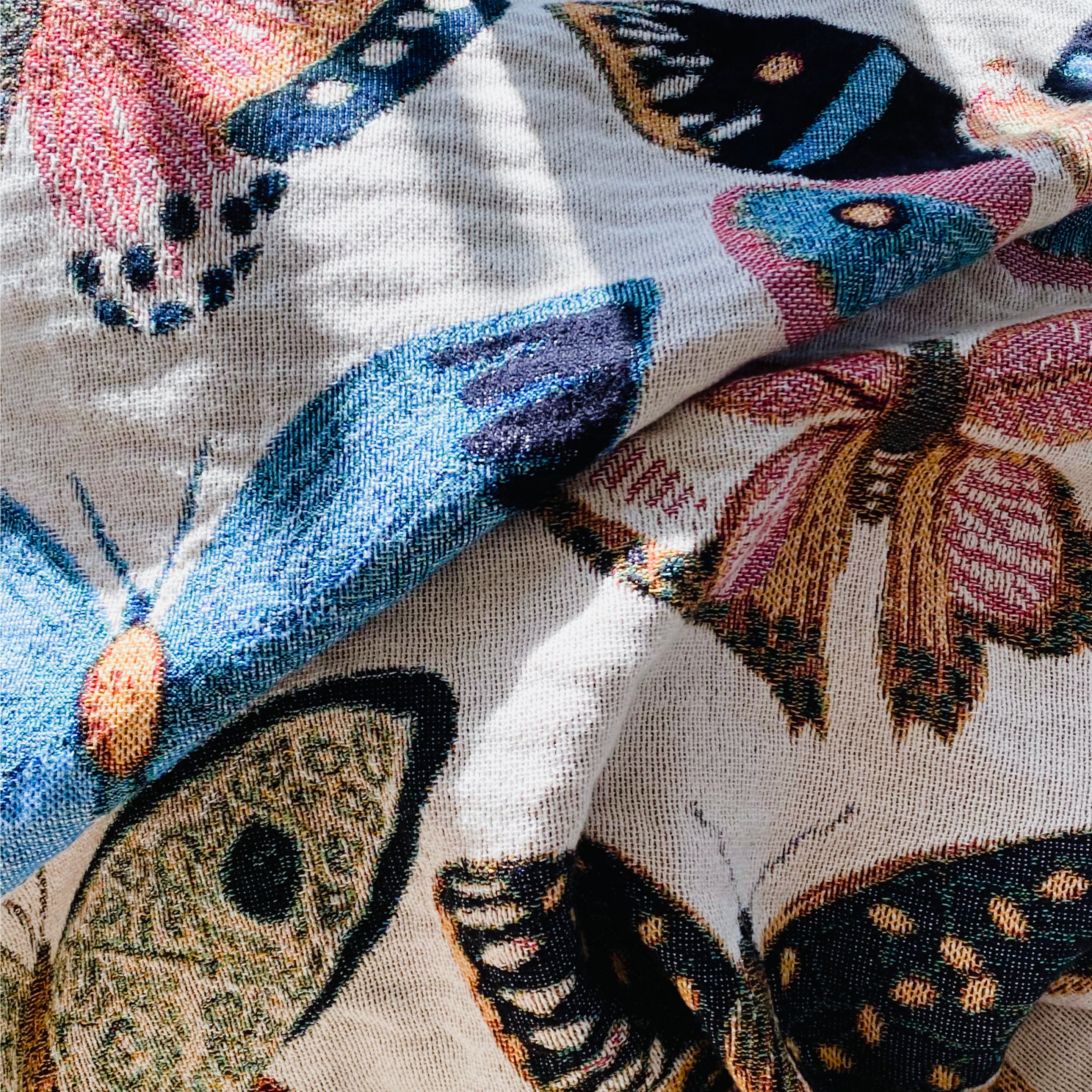 Colorful butterfly woven throw blanket displaying monarchs, swallowtails, and painted ladies creating a joyful flutter of nature-inspired beauty