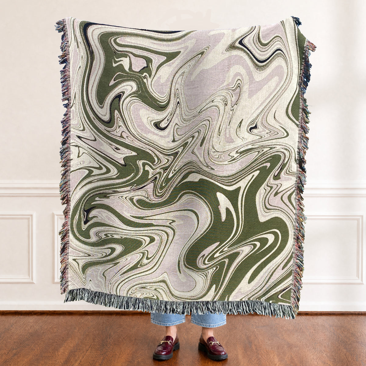 Woven blanket of swirling painted marble in olive green, soft lilac and cream, the colors flowing into each other like ink on water. Modern and relaxed, like a slow afternoon that drifts by. It can be personalized. The Painted Marble.